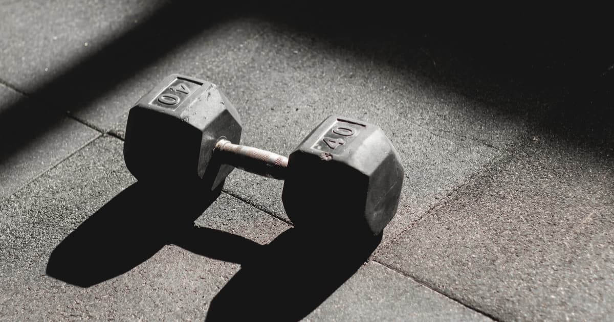 A 40-pound dumbbell on a gym floor ready for a custom strength workout
