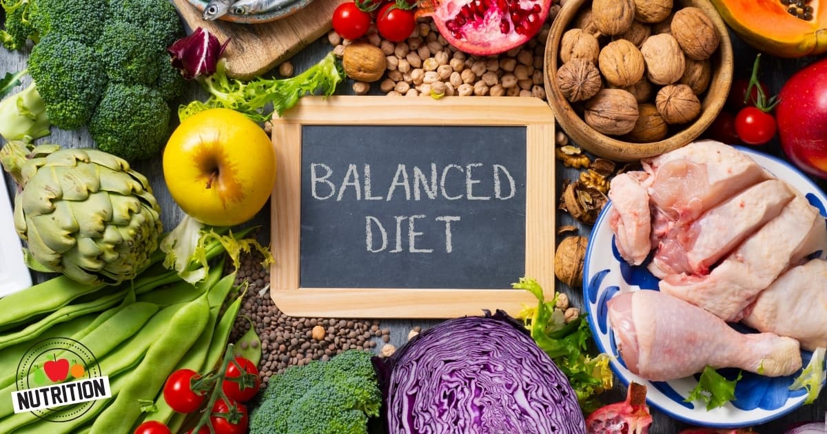 Whole foods surrounding a chalkboard that reads balanced diet